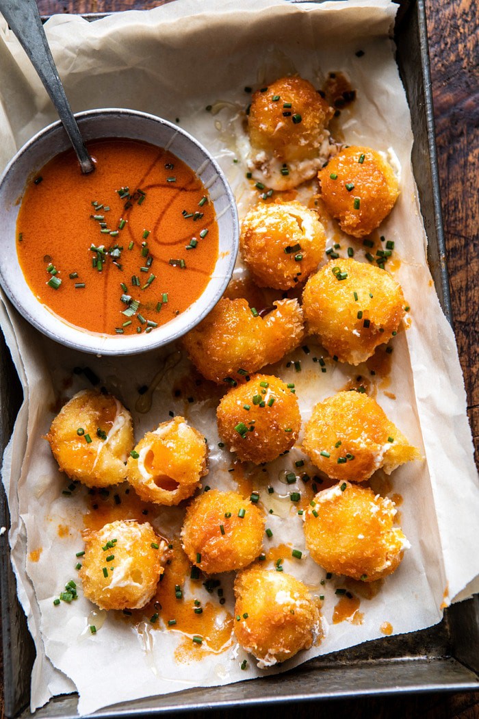 overhead photo of Fried Buffalo Goat Cheese Balls with buffalo sauce in bowl
