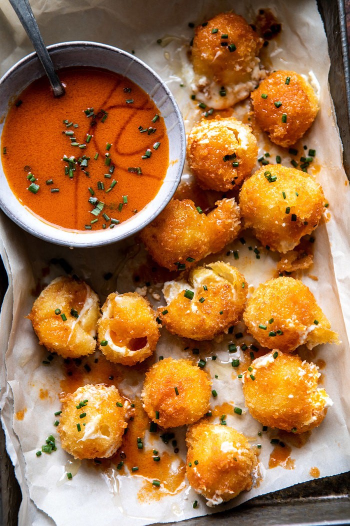 overhead photo of Fried Buffalo Goat Cheese Balls with cheese oozying out