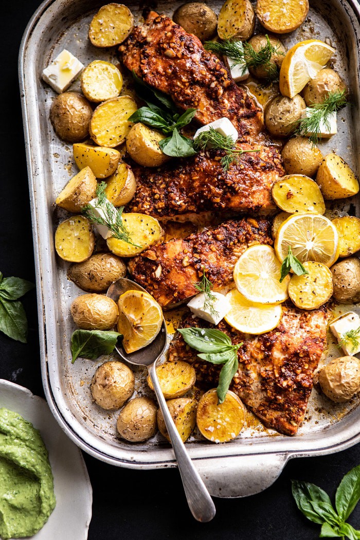 Sheet Pan Blackened Salmon Bowl with Potatoes and Avocado Goddess Sauce on baking sheet with spoon 