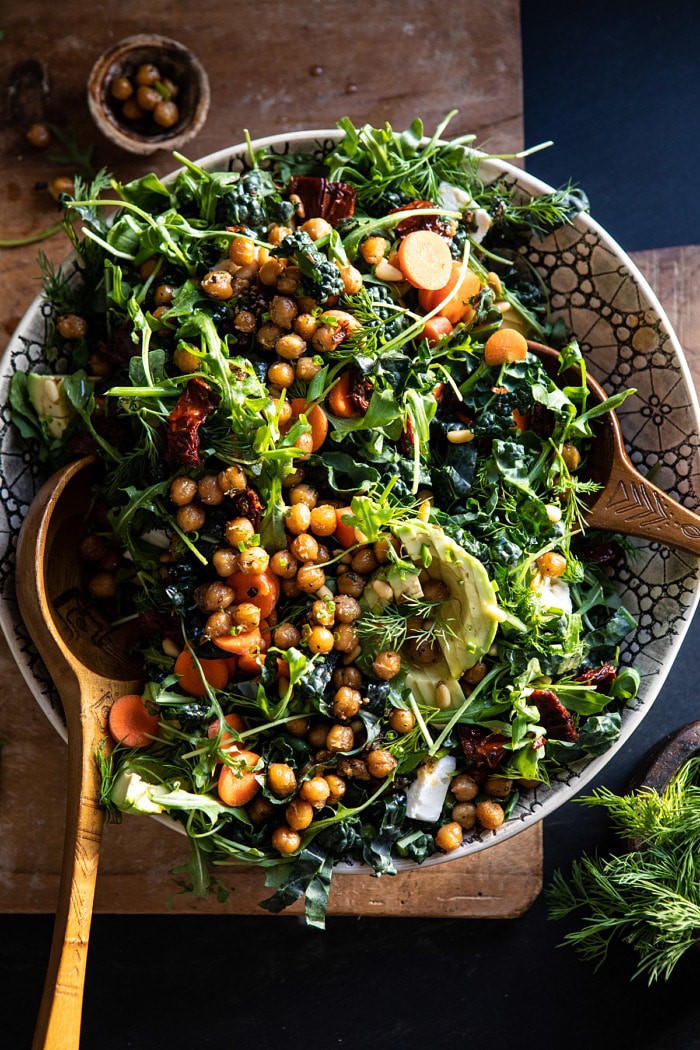 overhead photo of Super Green Sun-Dried Tomato Herb Salad with Crispy Chickpeas tossed in a bowl