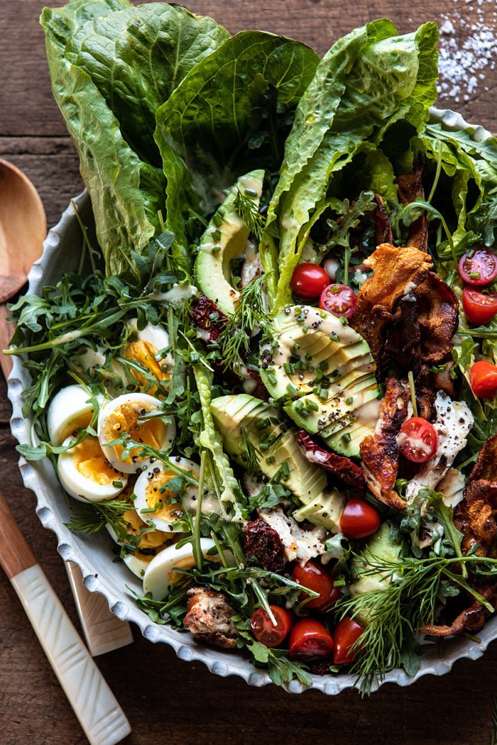 overhead close up photo of Sun-Dried Tomato Chicken and Avocado Cobb Salad with Tahini Ranch