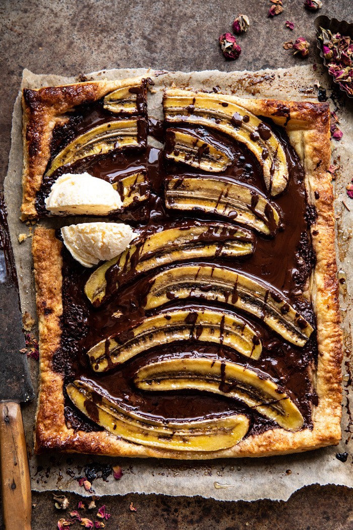 overhead photo of Warm Chocolate Banana Galette with square cut out and ice cream on top