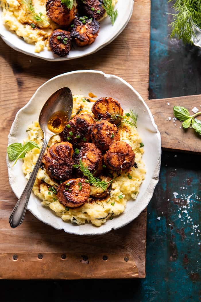 overhead photo of Honey Butter Blackened Scallops with Herby Polenta with spoon on plate