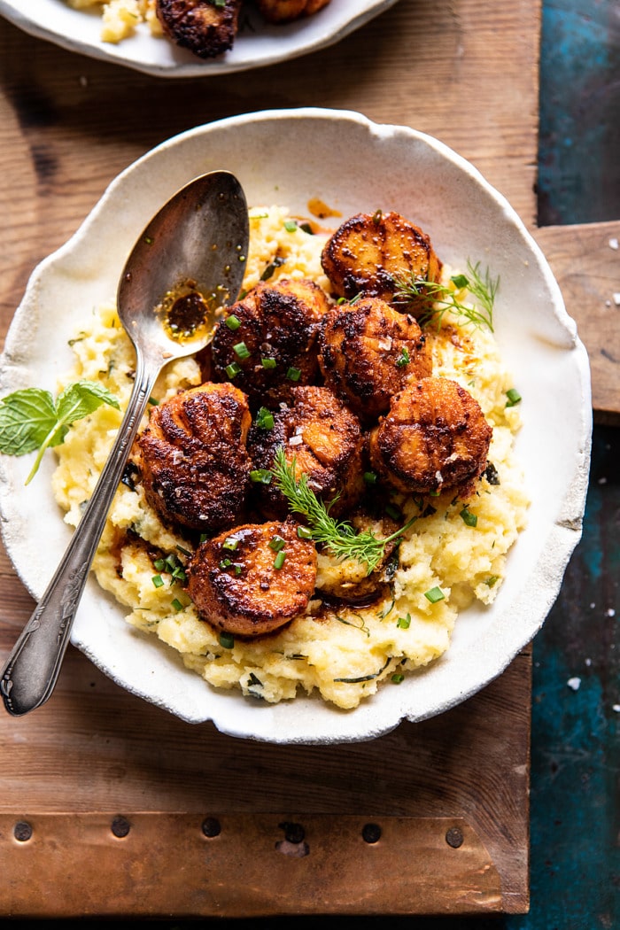 overhead close up photo of Honey Butter Blackened Scallops with Herby Polenta with spoon on plate