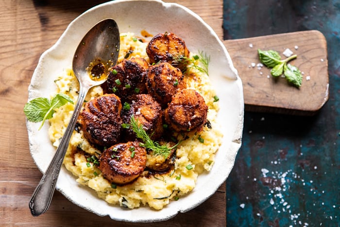 overhead horizontal photo of Honey Butter Blackened Scallops with Herby Polenta 