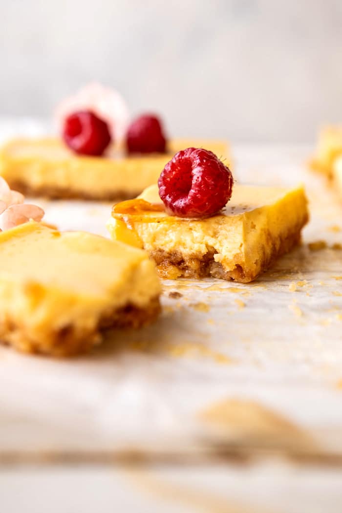 side angled photo of broken in half Creamy Lemon Bars with Browned Butter Raspberries 