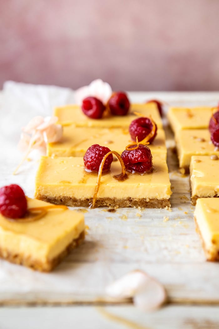 side angle photo of Creamy Lemon Bars with Browned Butter Raspberries