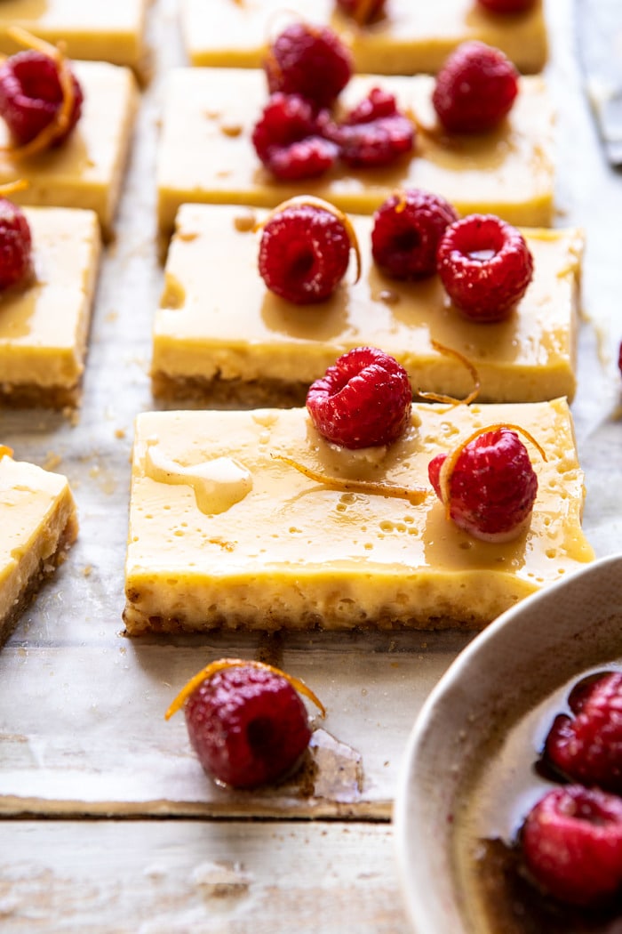 side angle photo of Creamy Lemon Bars with Browned Butter Raspberries 