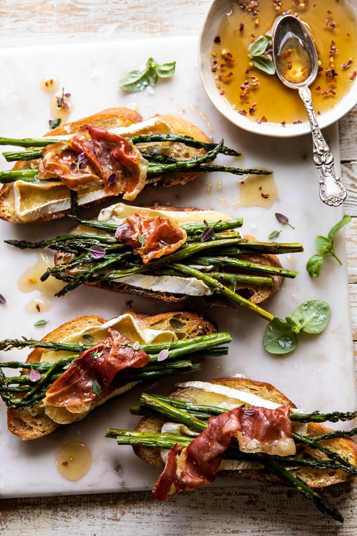 overhead photo of Crispy Prosciutto, Asparagus, and Brie Toast with hot honey in photo 
