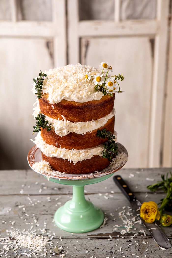 overhead photo of Lemon Coconut Naked Cake with Whipped Vanilla Buttercream on cake stand