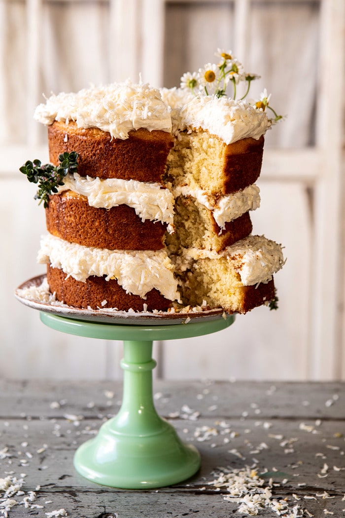 Lemon Coconut Naked Cake with Whipped Vanilla Buttercream with slice cut