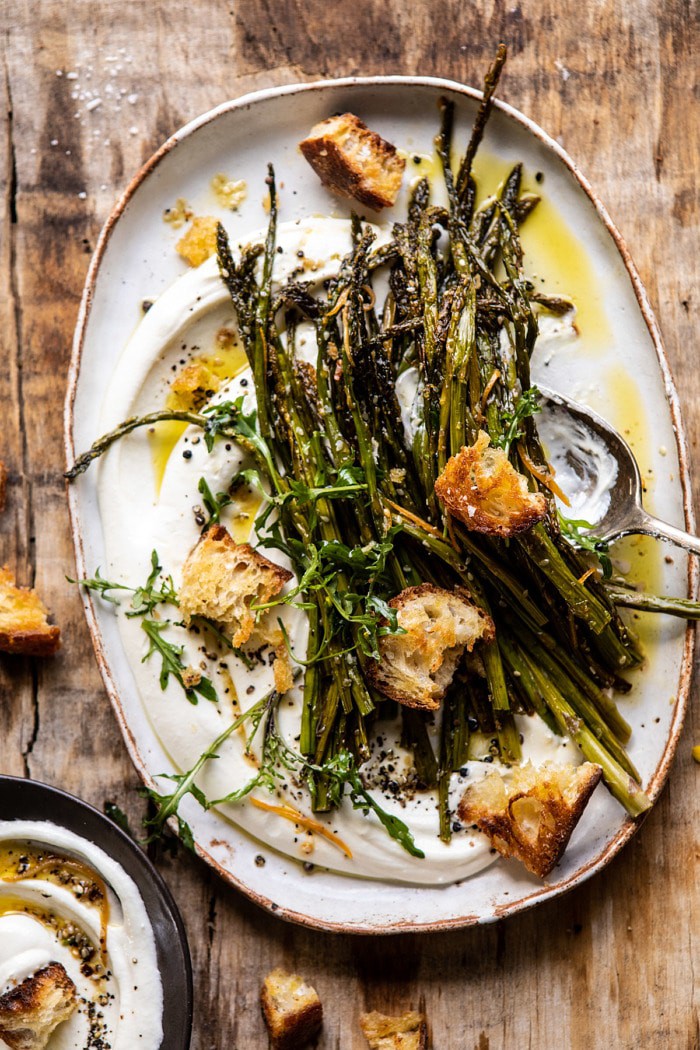 overhead photo of Sesame Roasted Asparagus with Whipped Feta and spoon on plate