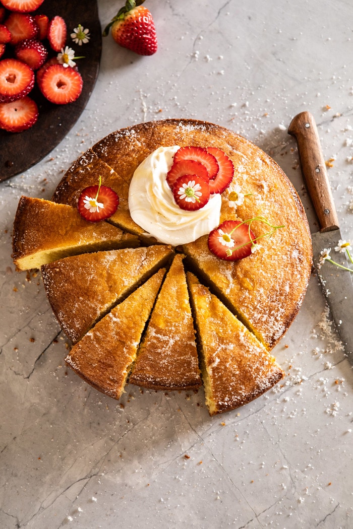 overhead photo of Strawberry Chamomile Olive Oil Cake with Honeyed Ricotta and 6 slices cut from cake