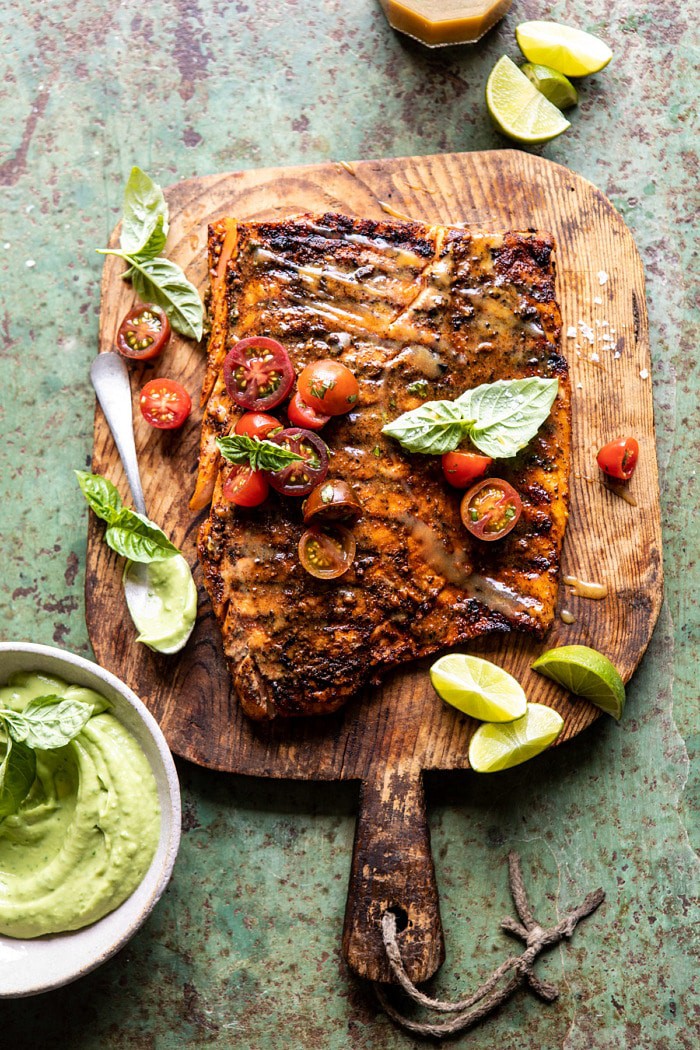 overhead photo of Honey Mustard Grilled Salmon with Avocado Basil Sauce on small cutting board