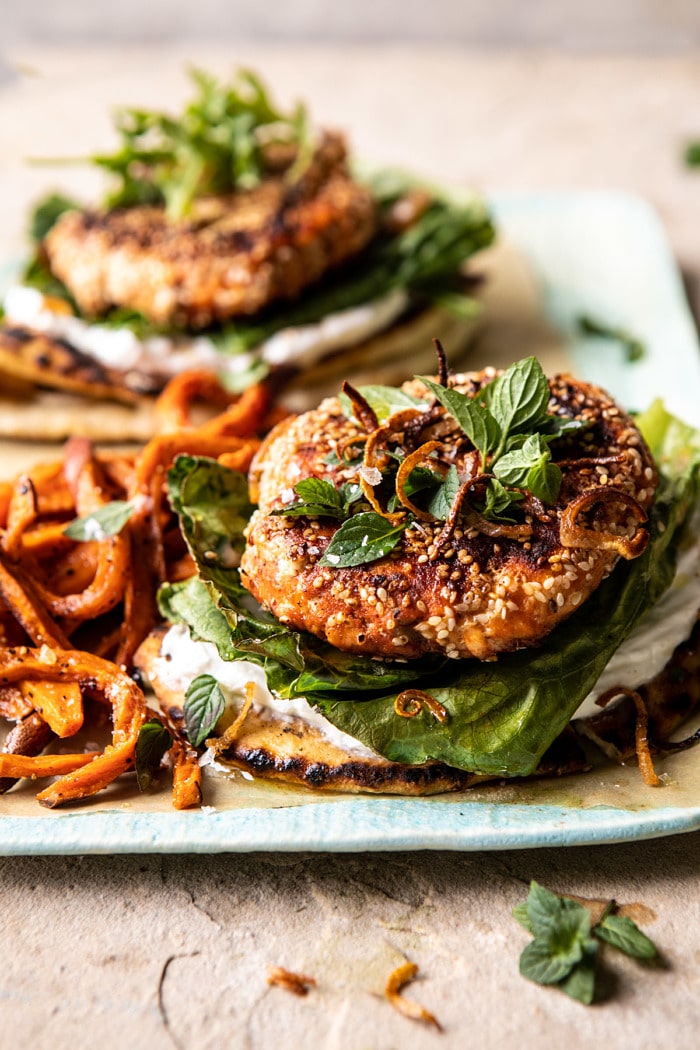 side angled close up photo of Sesame Crusted Curried Salmon Burgers with Lemony Herbs 