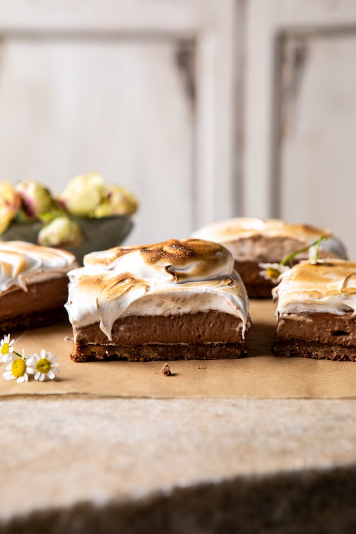side angled photo of S'mores Chocolate Mousse Bars with flowers in the background