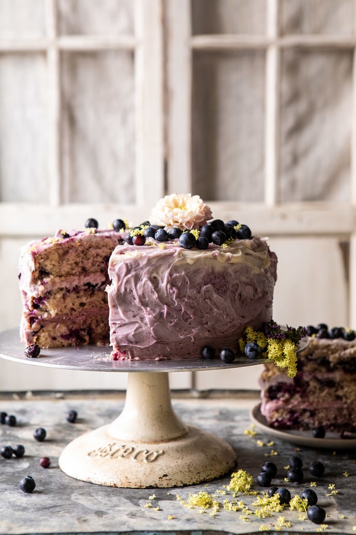 front on photo of Bursting Blueberry Lemon Layer Cake with slices cut out