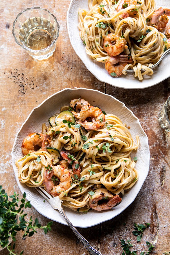 overhead photo of Garden Herb Shrimp Scampi Linguine with fork in bowl and wine glass on table