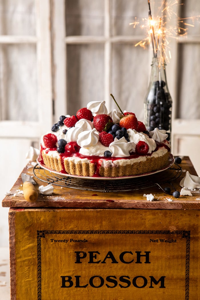head on photo of No-Bake Eton Mess Berry Cheesecake with sparklers in background of photo