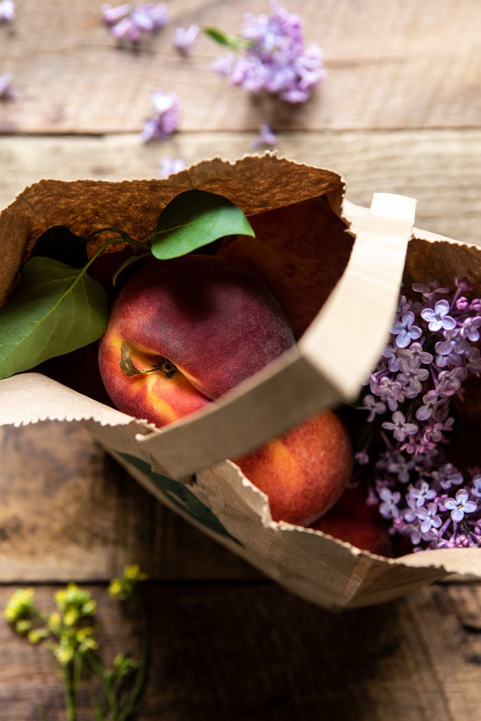 peaches in market bag with flowers