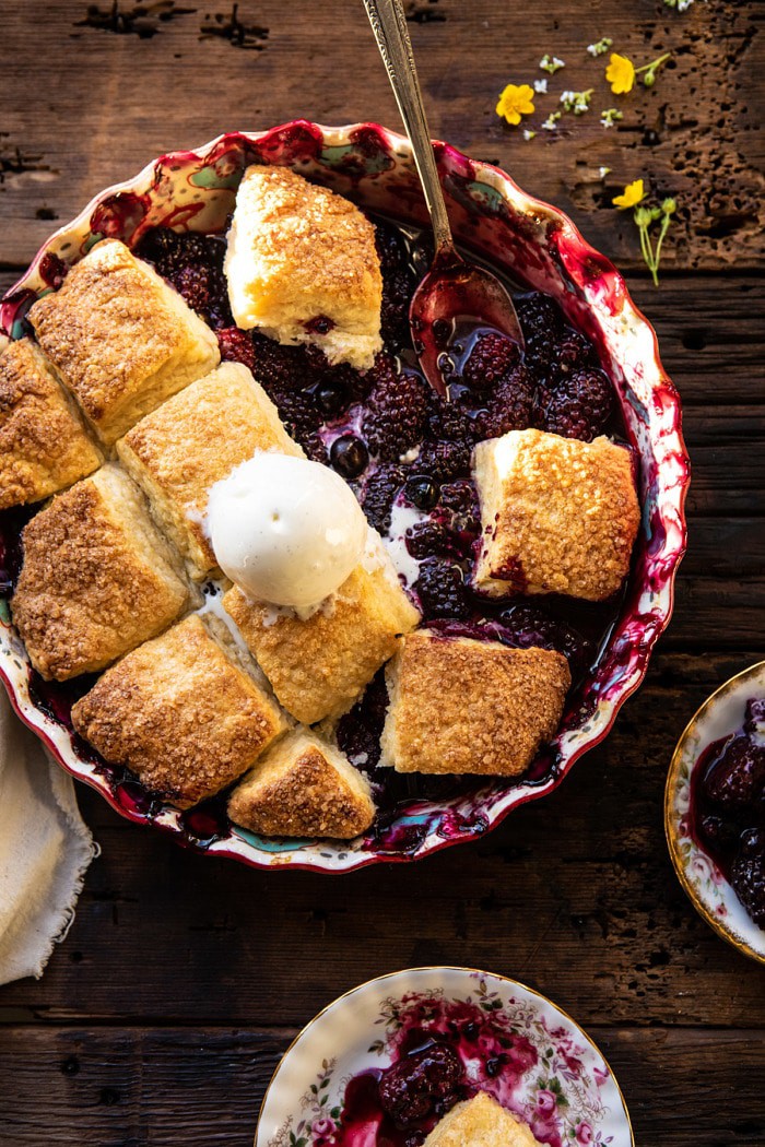 overhead photo of Blackberry Lavender Cobbler with servings of cobbler removed from dish and spoon resting in cobbler