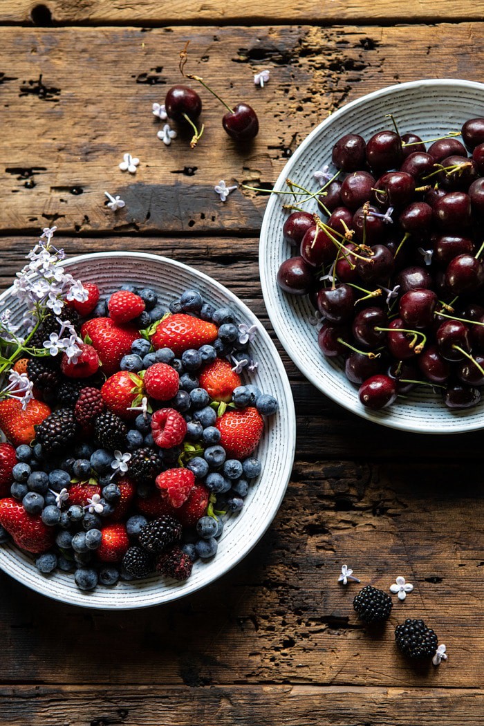 raw cherries and berries in bowls