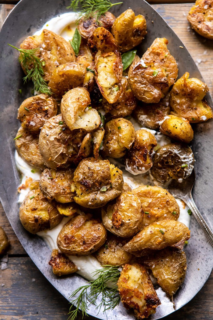 overhead close up photo of Crispy Salt and Vinegar Smashed Potatoes with portion of potatoes removed