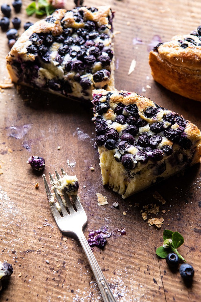side angled photo of Simple Blueberry Basque Cheesecake slice with bite take out of slice