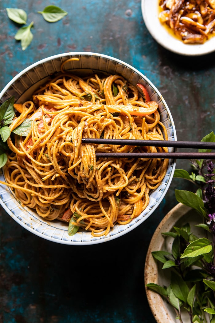 overhead photo of Spicy Peanut Noodles with Chili Garlic Oil and chopsticks in bowl