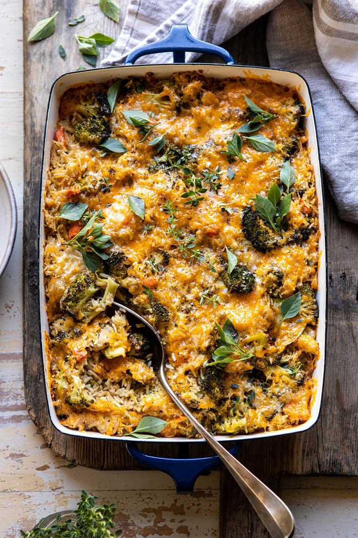 overhead photo of Broccoli Cheddar Chicken and Rice Casserole with spoon in casserole dish