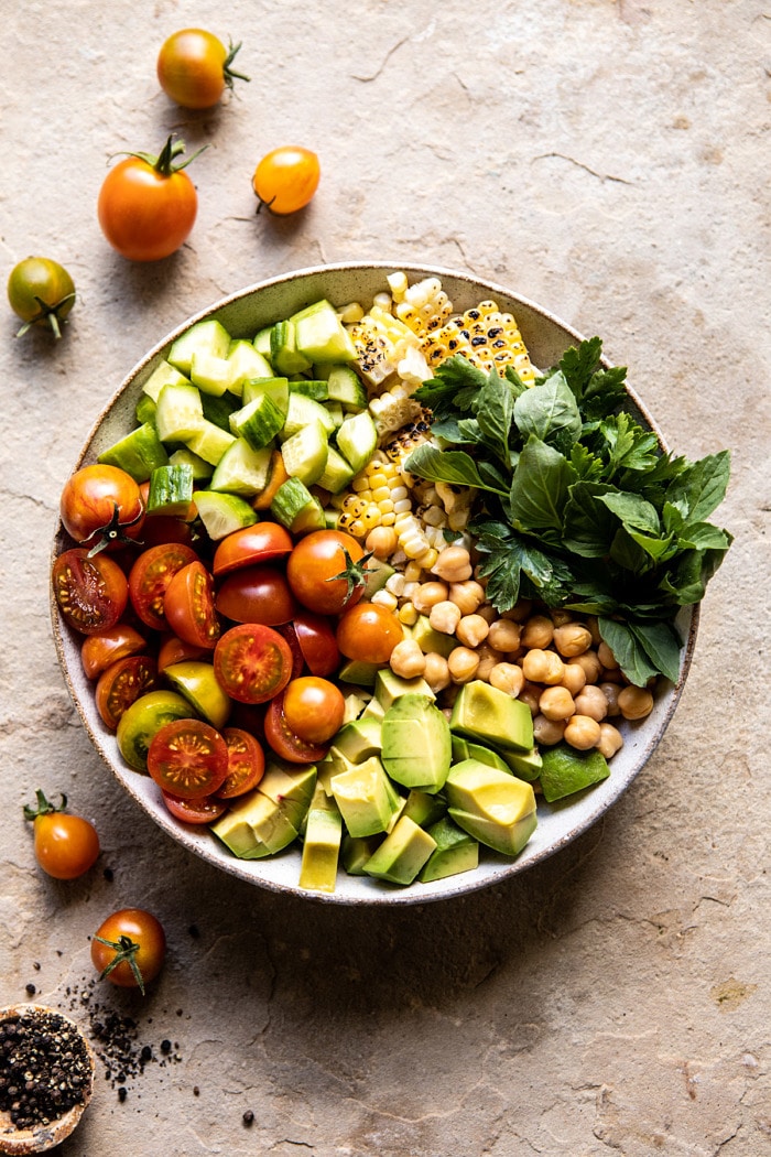 overhead photo of Corn, Tomato, and Avocado Chickpea Salad before tossing 