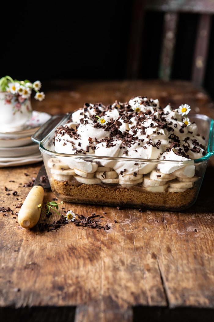 side angled photo of Healthier Banoffee Pie with plates on surface and chair in background
