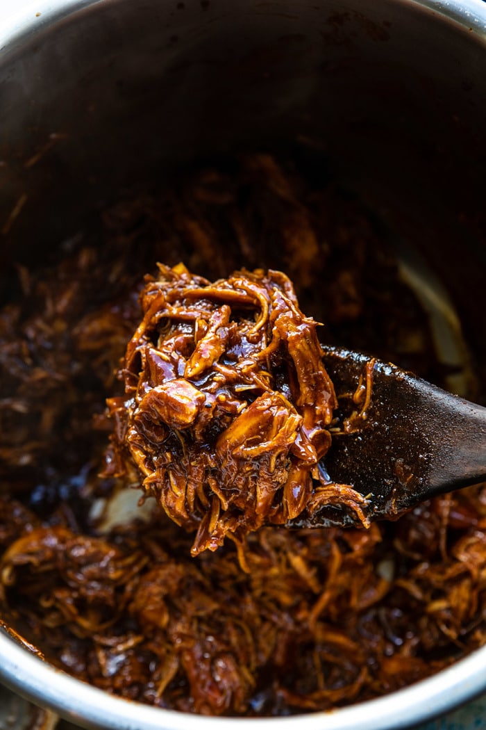 overhead photo of Instant Pot BBQ Beer Pulled Chicken in instant pot bowl 
