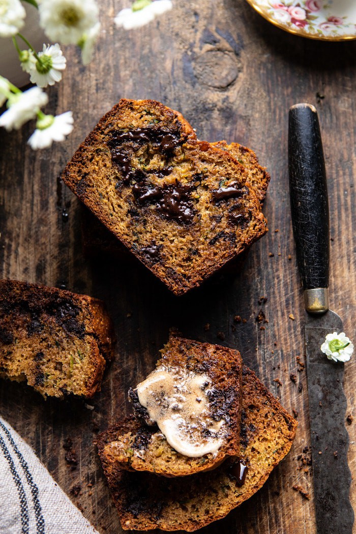 overhead photo of Sneaky Zucchini Chocolate Chunk Coconut Bread with butter on bread