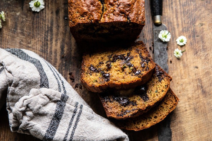 horizontal photo of Sneaky Zucchini Chocolate Chunk Coconut Bread with 3 slices cut