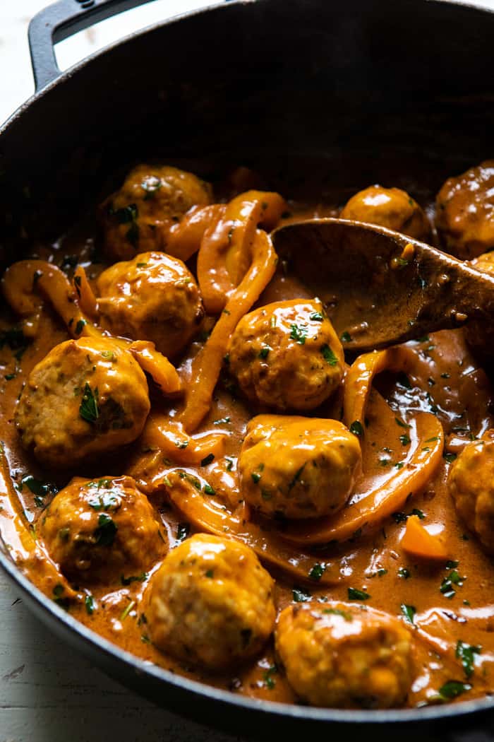 side angled photo of Weeknight 30 Minute Coconut Curry Chicken Meatballs in skillet 