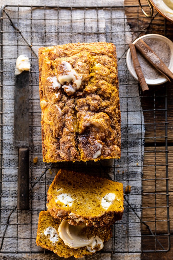 overhead close up photo of Cream Cheese Swirled Pumpkin Bread with 2 slices of bread cut