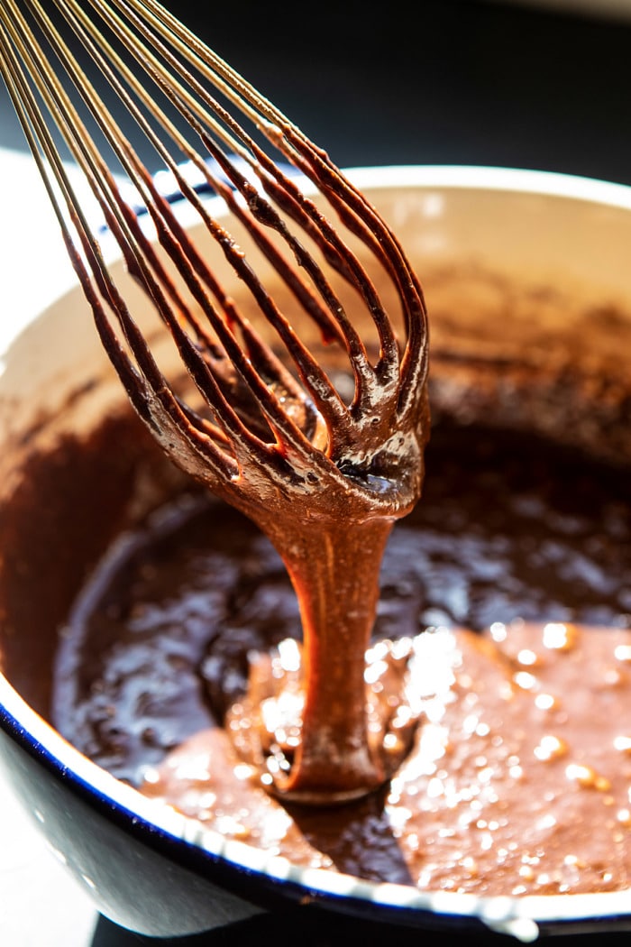 wet brownie mix in bowl with whisk 
