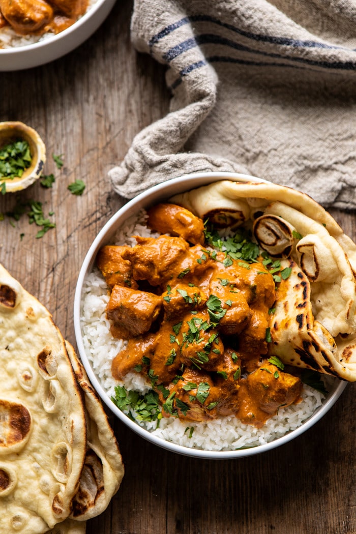 overhead photo of Super Simple Coconut Chicken Tikka Masala with towel in photo 