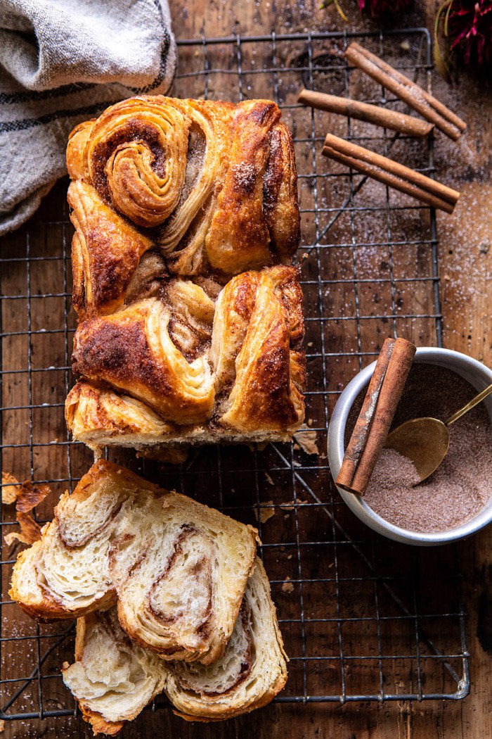 overhead photo of Easy Swirled Cinnamon Sugar Croissant Loaf with 2 slices of bread cut and cinnamon sugar in photo