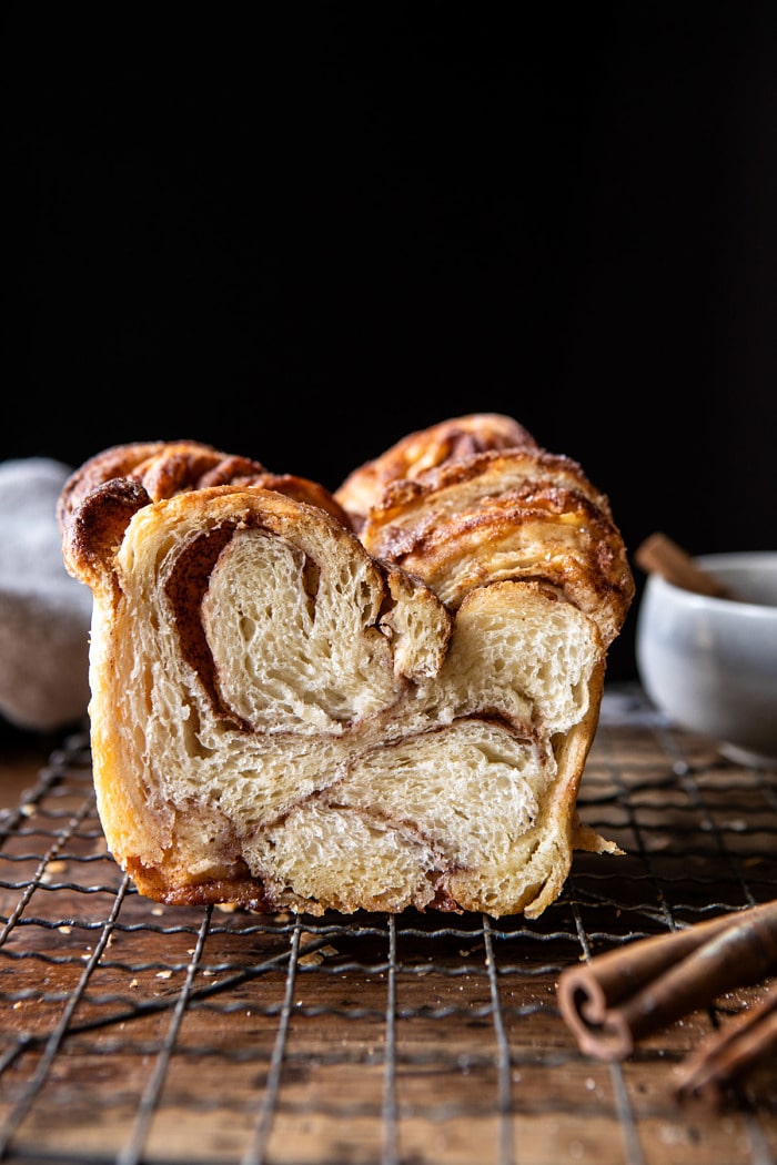 side angled photo of Easy Swirled Cinnamon Sugar Croissant Loaf with loaf cut in half to show the inside 