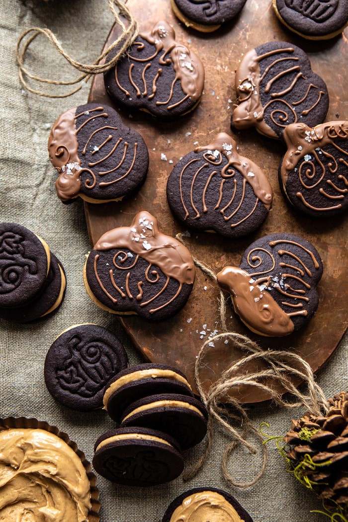 overhead photo of Peanut Butter Stuffed Chocolate Jack-O’-Lantern Cookies on serving trey