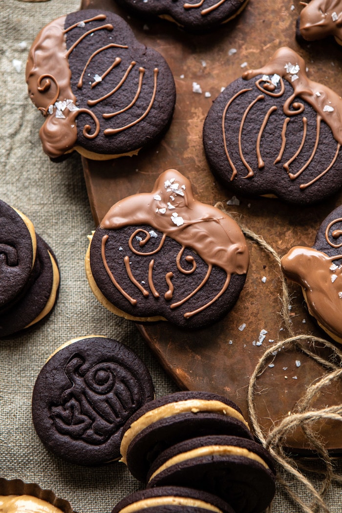 overhead close up photo of Peanut Butter Stuffed Chocolate Jack-O’-Lantern Cookies on serving trey