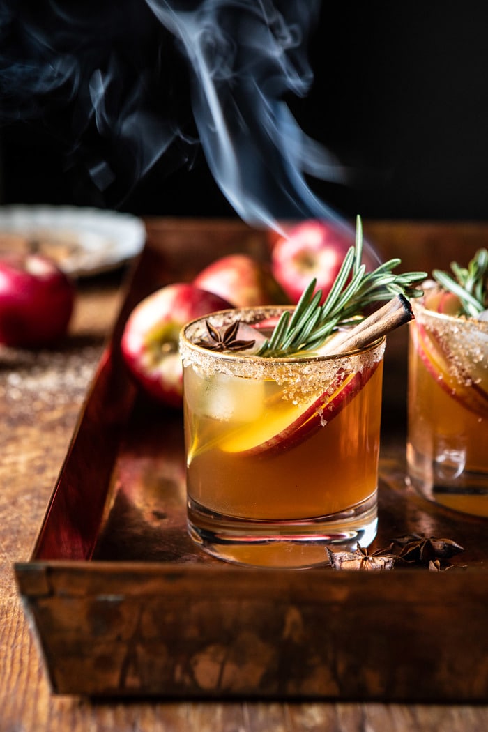 side angled photo of Smoky Harvest Apple Cider Margarita with smoking cinnamon stick 