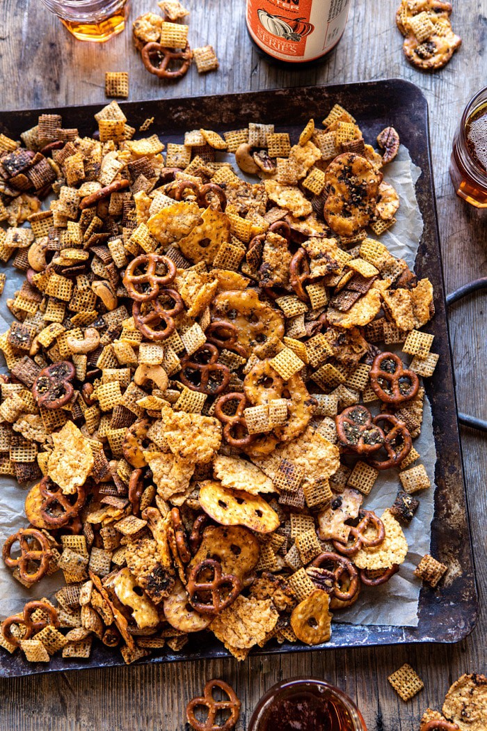overhead photo of Spicy Ranch Chex Mix on serving plate with beers in 
