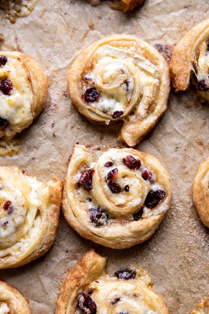 overhead photo of 5 Ingredient Cranberry Brie Cinnamon Puff Pastry Swirls on baking sheet after baking 