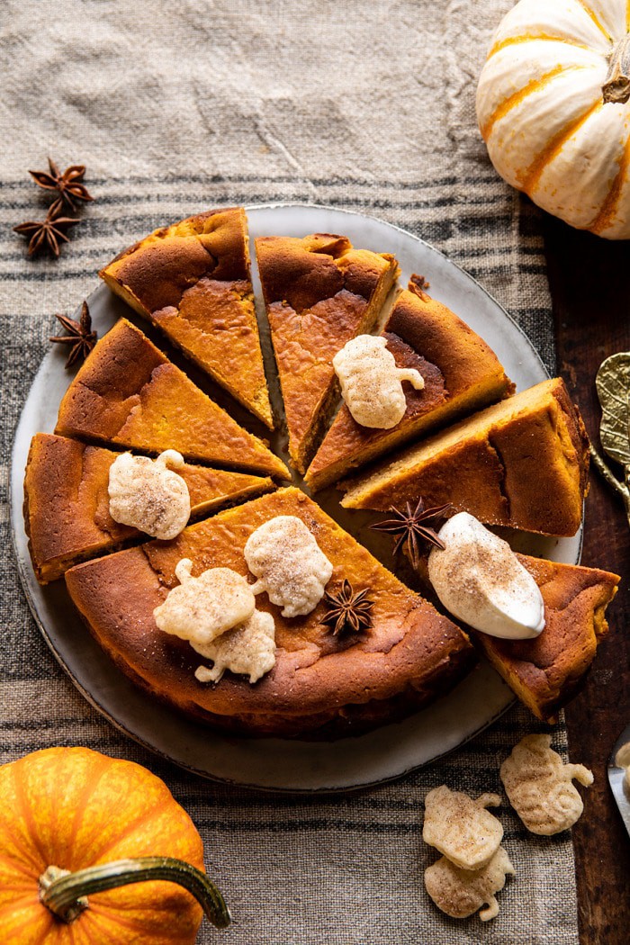 overhead photo of Burnt Basque Pumpkin Spice Cheesecake with multiple sliced of cheesecake cut
