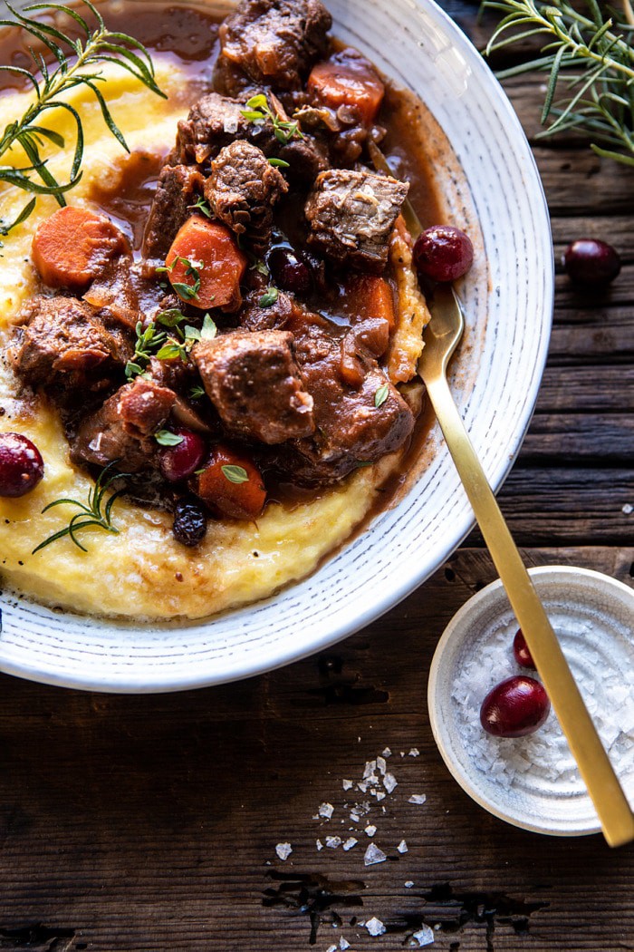 overhead photo of Cranberry Cider Braised Beef Stew with Rosemary Polenta with fork in bowl 