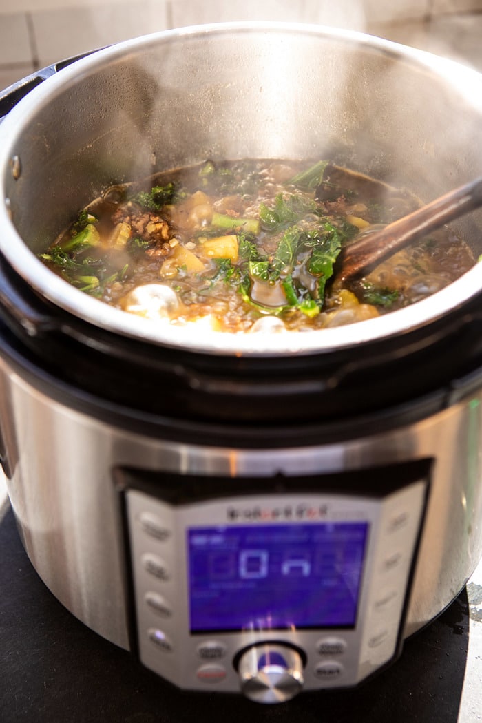 Instant Pot Pesto Zuppa Toscana in instant pot while cooking, before adding cream