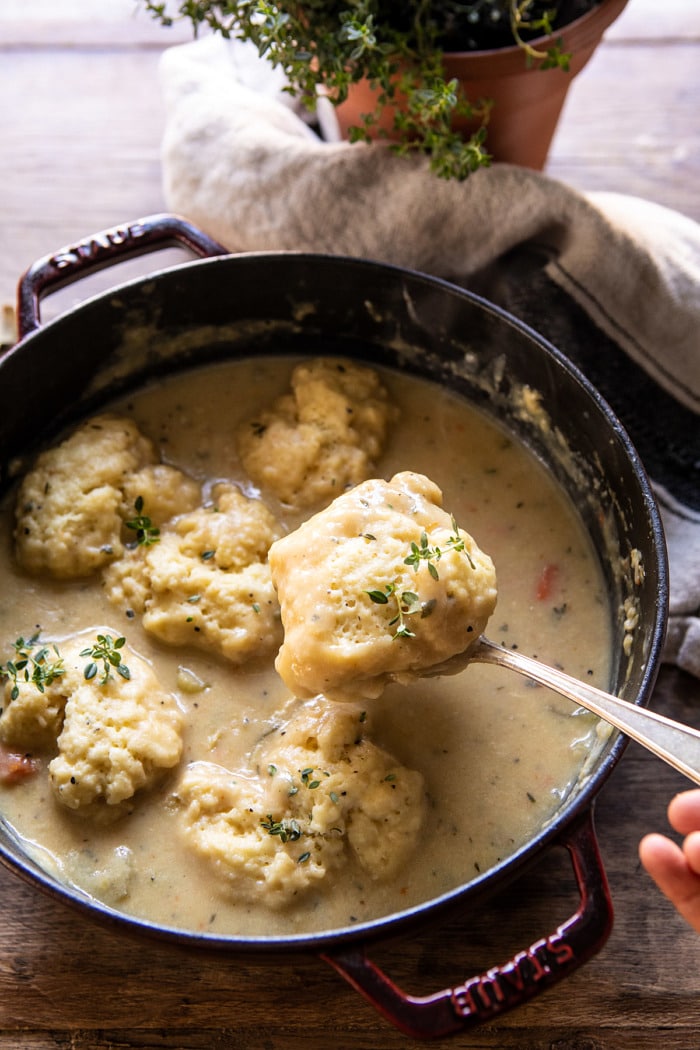 overhead photo of One Pot Creamy Turkey and Potato Dumplings with serving spoon spooning a dumpling out of the pot